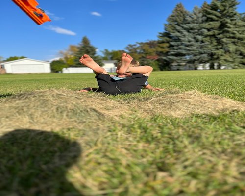 Person stretching outdoors in sunlight
